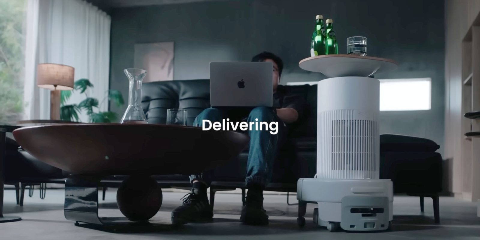 The SwitchBot K20+ Pro is the silliest robot vacuum cleaner, seen here delivering drinks