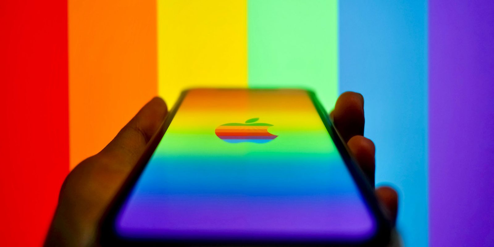Apple won't be fined by the EU over browser choice, after second change | iPhone with rainbow Apple logo and rainbow stripes